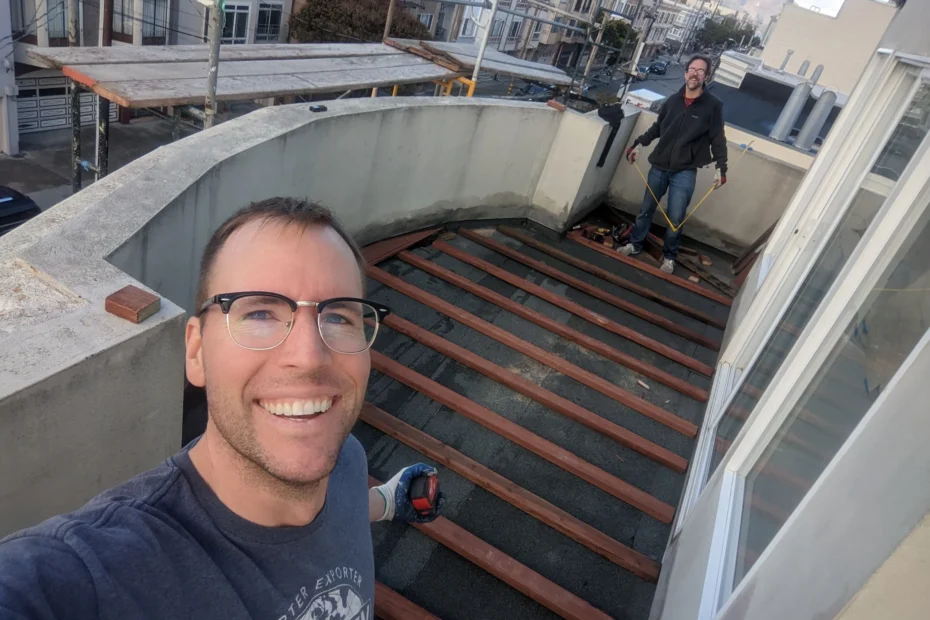 Christian and teammate working on a wooden deck improvement project.